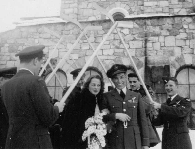 News Photo: R.C.A.F. Flyers Hold Arch of Hockey Sticks As Newly Weds Birthe and Hubert Brooks Exit Church 2