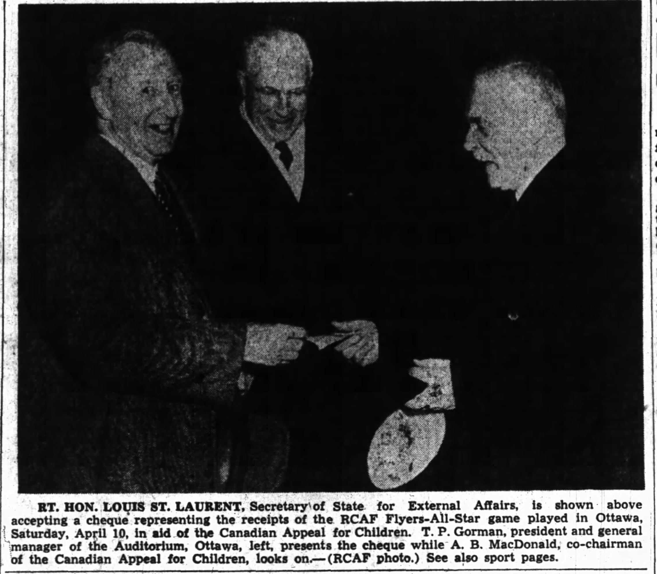 Photo: Right Honorable Louis St Laurant receives check from April 10  1948 Charity hockey  game RCAF Flyers vs NHL QSHL All Stars