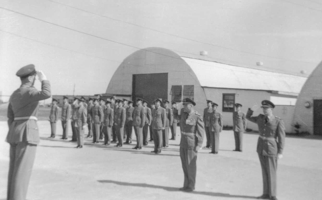 Photo: W/C Hubert Brooks enters Parade Ground to Take Salute from Acting CO Ralph MacWilliam 