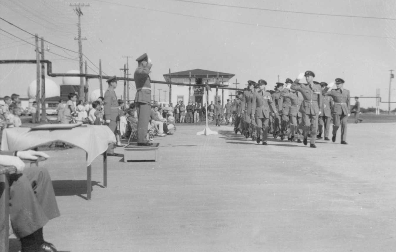 Photo: W/C Hubert Brooks takes salute as Station Airman led by S/L Ralph MacWilliam March Past 