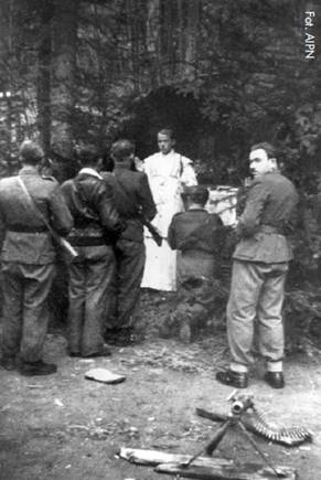 Photo of Priest saying mass with machine gun in foreground