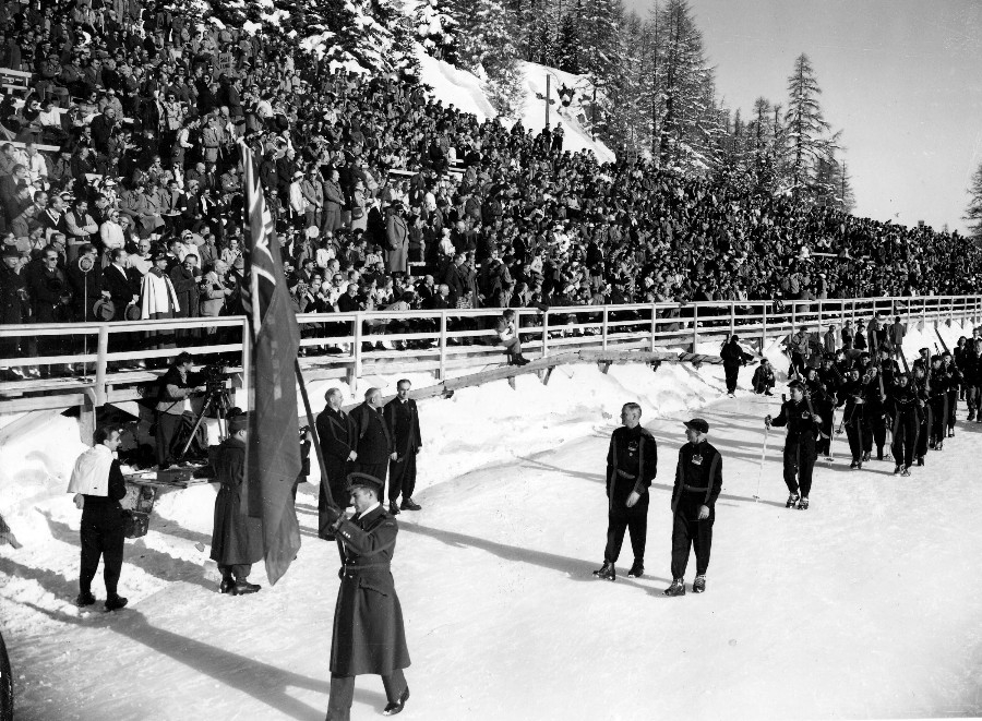 Photo: Hubert Brooks Carrying Canadian Flag Past Grandstand 1948 Winter Olympics
